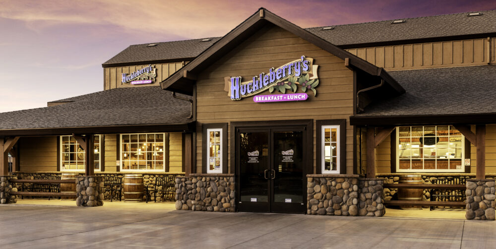 Entrance to Huckleberrys with a sunset behind the building.