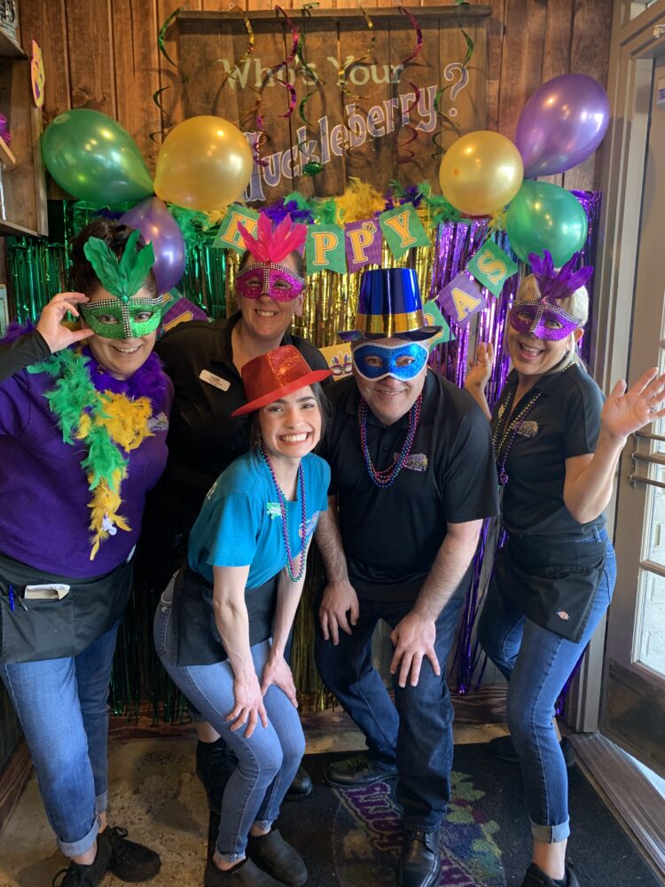 A group of people in mardi gras attire.